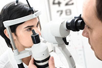 Eye specialist checking eyes